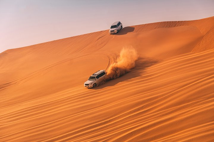 Experience the excitement of dune bashing in the stunning desert landscape combining traditional culture and modern thrills for a memorable adventure in Dubai.